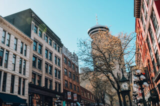 Streetscape of Gastown heritage buildings, looking towards steam clock and Harbour Centre tower